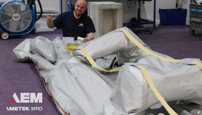 Technician working on a deflated escape slide